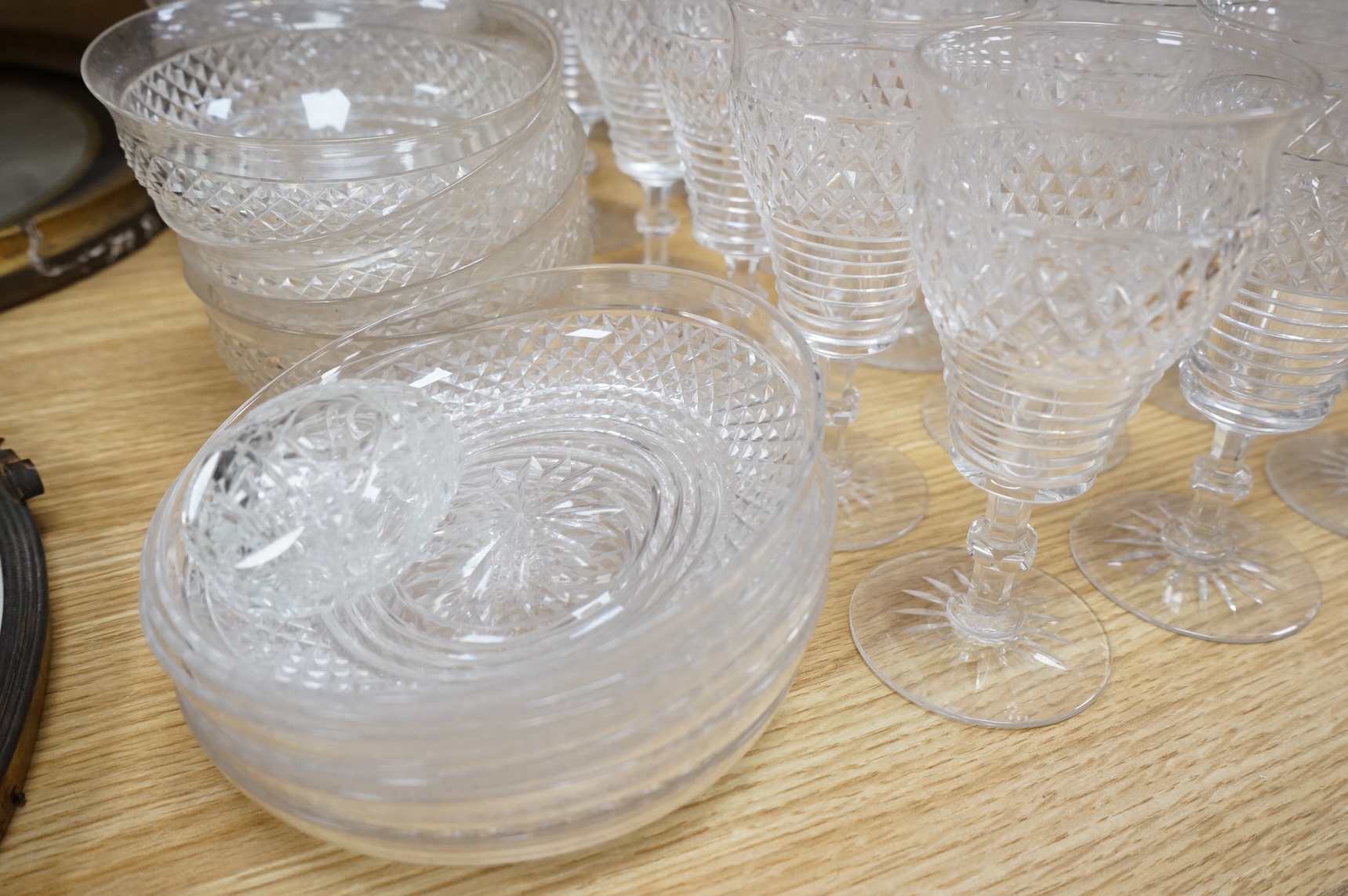 A suite of early 20th century cut table glass, custard glasses, a tall stemmed etched glass, etc., etched glass 24cm high